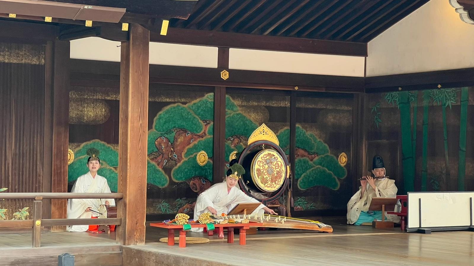 Gagaku court music performance with musicians in white robes, Kyoto